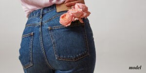 Close Up of Woman's Buttocks With Flowers in Back Pocket of Jeans